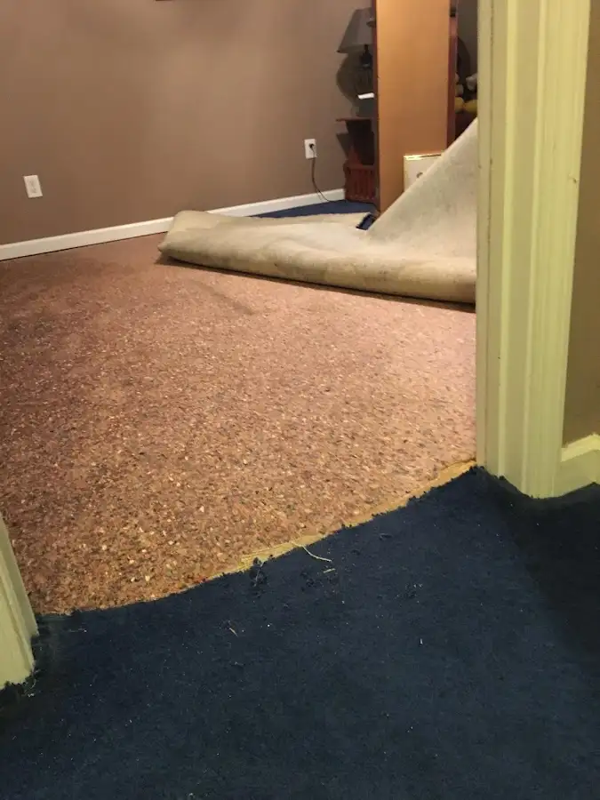 Carpet pad removal revealing water damage during Drying & Dehumidification in Kerman